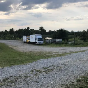 a truck and trailer parked in a field