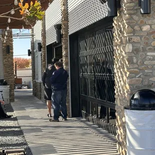 two men walking down the sidewalk