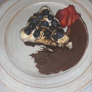 a slice of cake with chocolate and strawberries