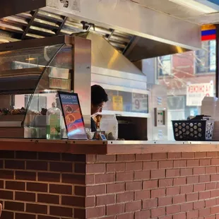 a woman ordering food at a restaurant