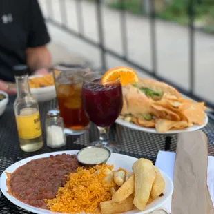 Vegan plate, chicken sandwich, sides of rice and collards, sangria, iced tea