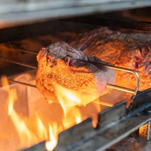 Delicious usda prime ribeye grilling over open flame