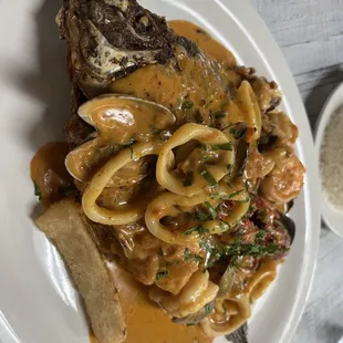 a plate of pasta and meat