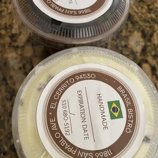 two plastic containers of cheese