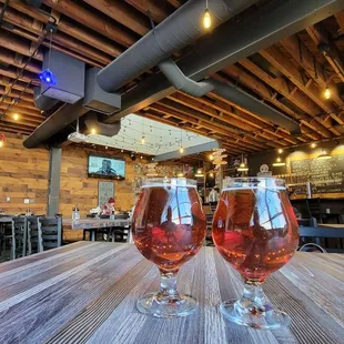 two glasses of wine on a wooden table