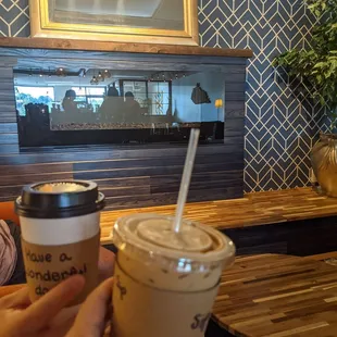 a person holding a cup of coffee