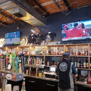 a man behind the bar at a sports bar