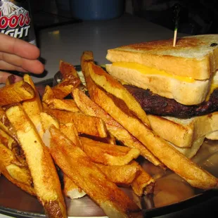 Cheeseburger in between 2 grilled cheese sandwiches