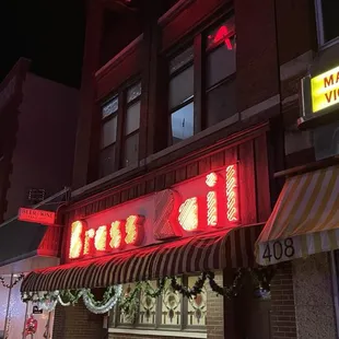 red neon sign and awning