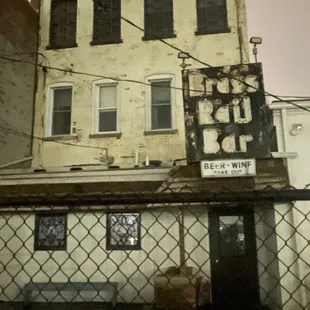 a chain link fence in front of a building