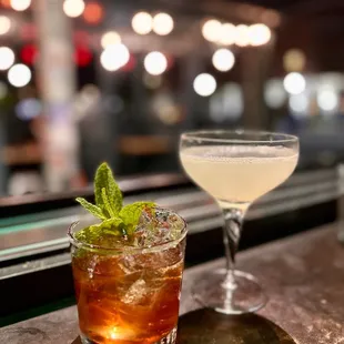 a cocktail and a drink on a table