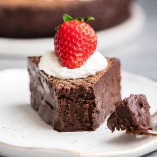 a piece of chocolate cake with a strawberry on top