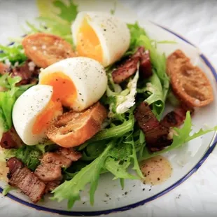a salad with eggs and bacon