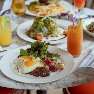 a table with plates of food and drinks