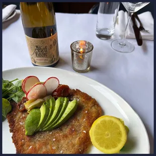 a plate of food and a bottle of wine