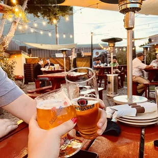 two people toasting at an outdoor restaurant