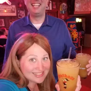 a man and a woman holding drinks