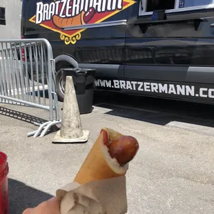 Brat in front of their truck