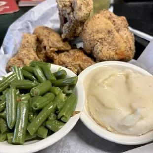 Half fried chicken dinner with green beans, mashed potatoes and gravy and slaw (mia). I&apos;m am told all of the locals dine here also.