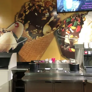 an ice cream parlor with a large mural of ice cream cones
