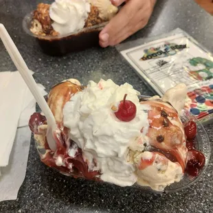 a sundae with whipped cream and cherries