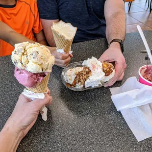 three people eating ice cream cones