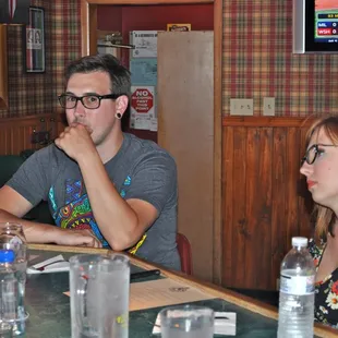 a group of people sitting around a table