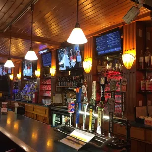 a bar with a bar top and a television on the wall