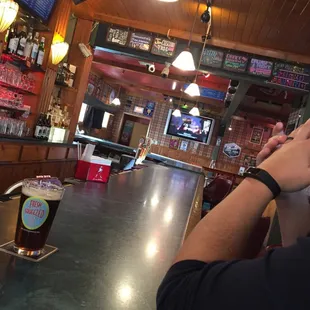 Cozy bar. Who doesn't love plaid wallpaper?