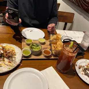 a man sitting at a table with plates of food