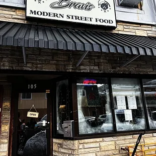 the entrance to a modern street food restaurant