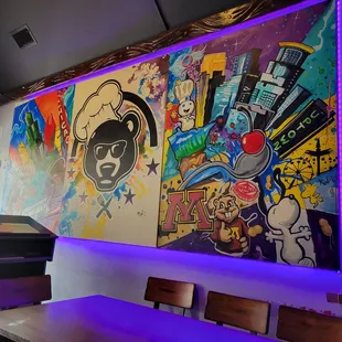 a mural of graffiti on the wall of a restaurant
