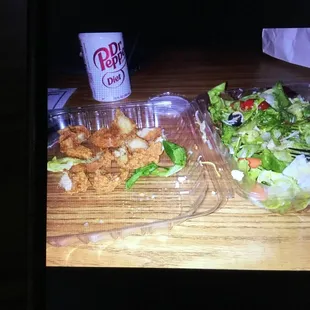 a salad and a drink on a table