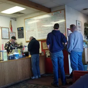 a group of people standing at a counter