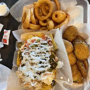 Shredded chicken nachos, fried zucchini and onion rings.