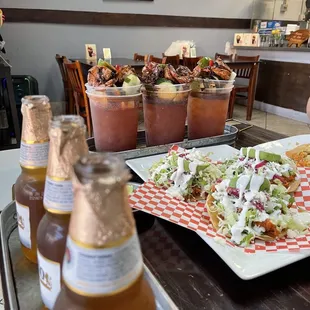a plate of food and bottles of beer