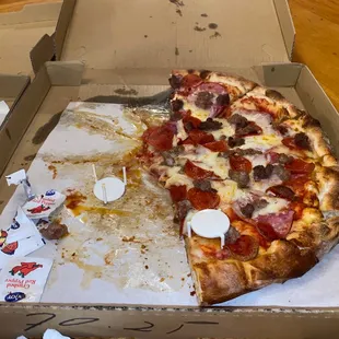 a half eaten pizza in a box