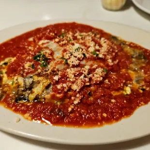 a plate of pasta with sauce and parmesan cheese