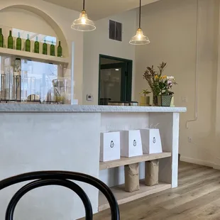 a kitchen with a counter and chairs