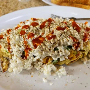 Vegetable omelet with sausage cut up inside, then smothered in cottage cheese and Cholula sauce!