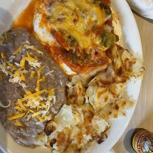 Huevos rancheros, with perfectly cooked eggs over medium, fresh refried beans, crispy potatoes. Perfection!