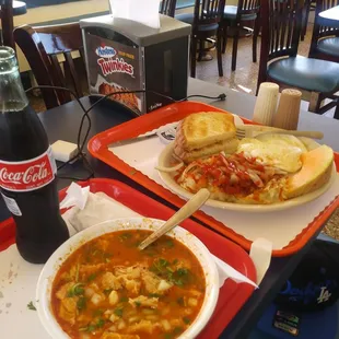 two plates of soup and a sandwich