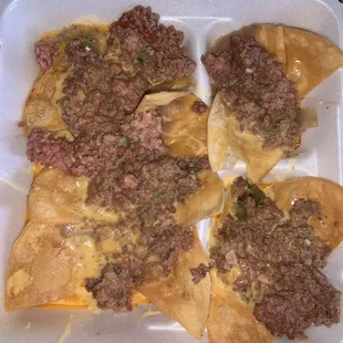 Raw pink ground beef in the Nacho Supreme