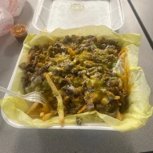 a tray of taco cheese fries