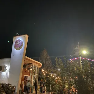 people standing outside at night