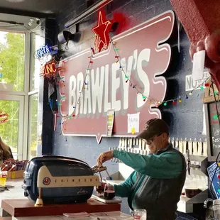 a man pouring a drink into a toaster