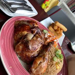 Half chicken with fried rice and yuca fries.