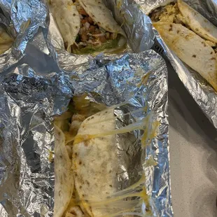 three burritos wrapped in foil