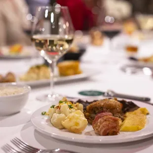 a plate of food and a glass of wine