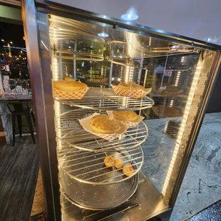 a display case filled with pies